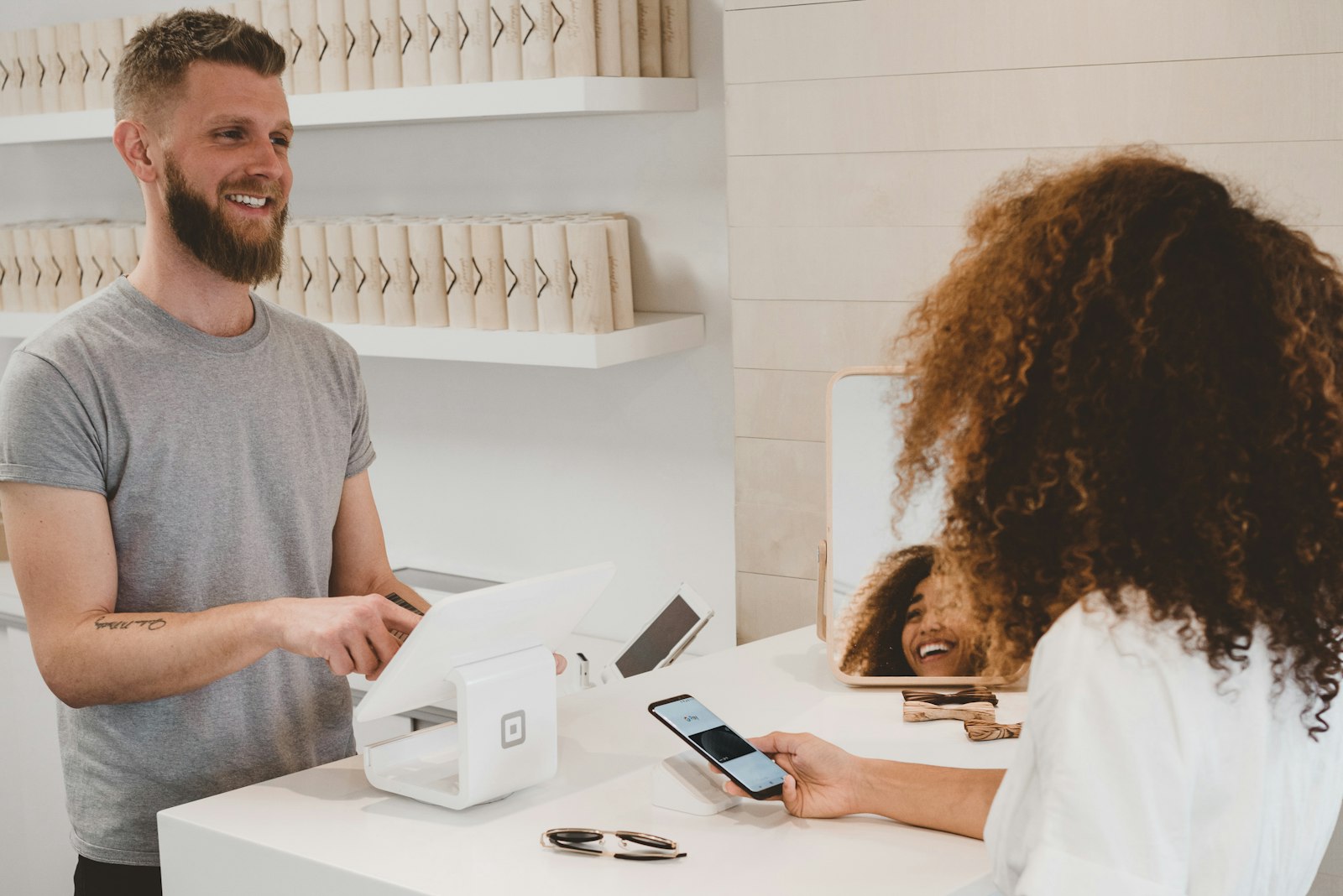 Retail associate completing a contactless payment on a tablet POS system